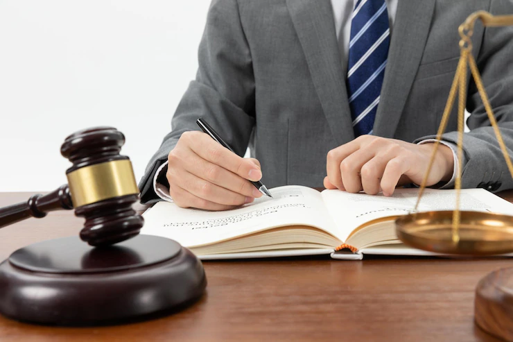A person signing a law book